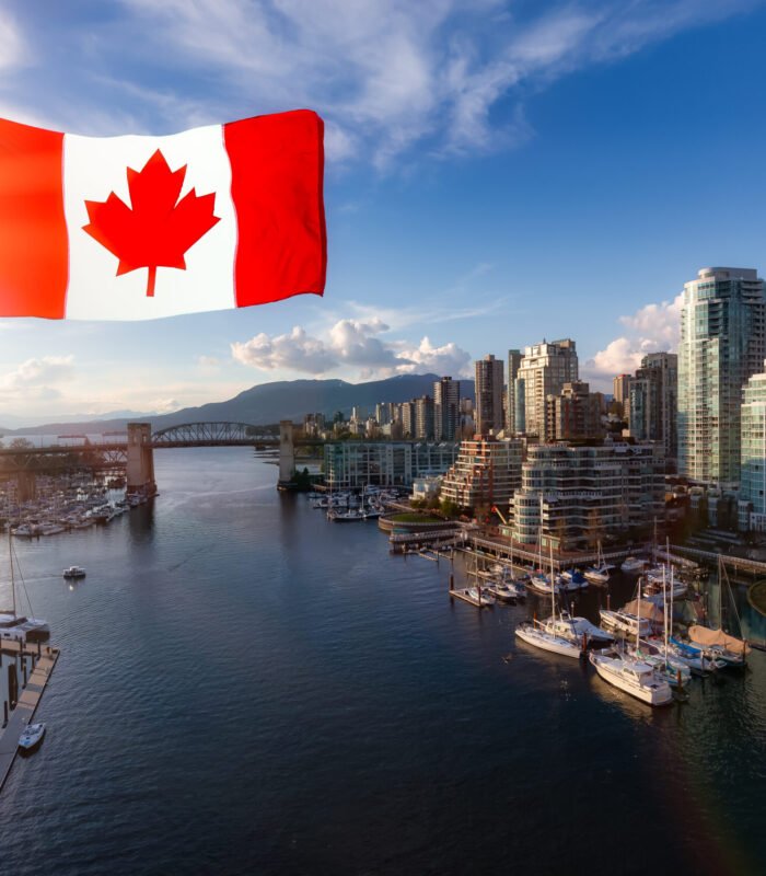 Canadian National Flag Overlay. False Creek, Downtown Vancouver, British Columbia, Canada. Beautiful Aerial View of a Modern City on the West Pacific Coast during a colorful Sunset.